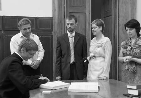 LUTSK, Volyn / UKRAINE - July 26 2009: Priest is signing significant document for wedding ceremony in churchのeditorial素材