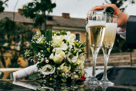 Poring champagne from the bottle into a glasses