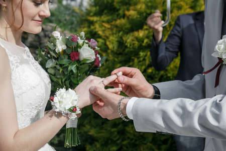 Close up Groom put the wedding ring on brideの写真素材