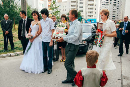 Lutsk, Volyn / Ukraine - August 30 2009: Parents bless the brides in the streetのeditorial素材
