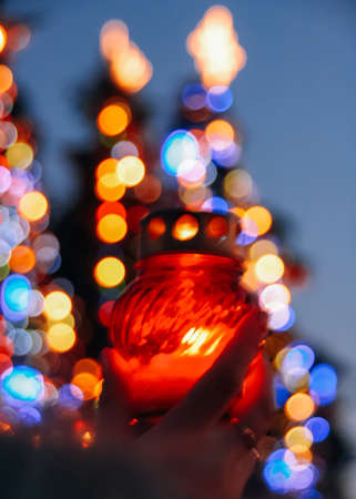 Hand holding lampion with a candlesの写真素材