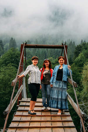 VERHOVYNA, Zakarpatia / UKRAINE - July 31 2012: Women and man posing on the suspension bridgeのeditorial素材
