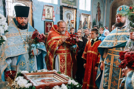 VOYUTYN, Volyn / UKRAINE - October 14 2009: Orthodox priest and church parishioners during holiday...