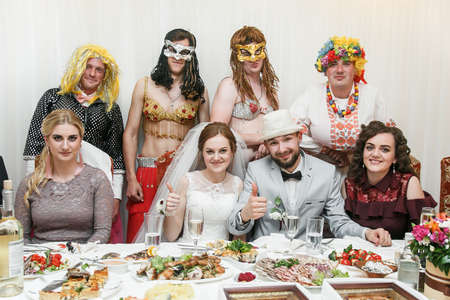 Cuman, Volyn / Ukraine - April 29 2018: Bride and groom with friends posing in a restaurantのeditorial素材