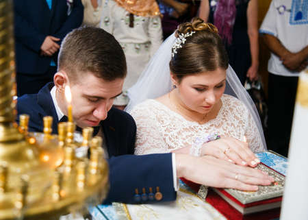 Lutsk, Volyn / Ukraine - September 16 2018: Oath at the newlyweds on luxuriously decorated bible in the churchのeditorial素材