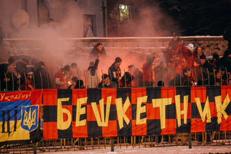 Lutsk, Volyn / Ukraine - November 28 2010: Football supporter fans with smoke watching soccer match...