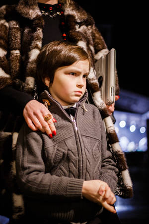 Lutsk, Volyn / Ukraine - November 17 2017: Young Mother embracing her son on street at nightのeditorial素材