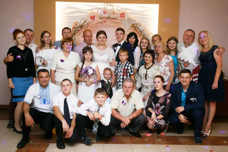 Lutsk, Volyn / Ukraine - September 16 2018: Groom and bride with guests posing in restaurantのeditorial素材