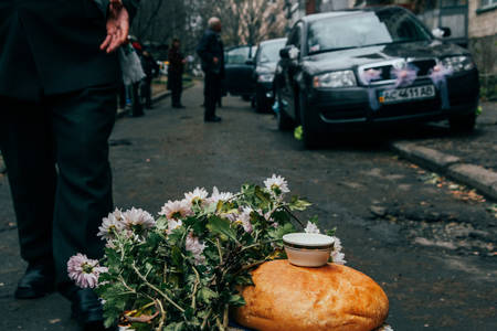 Lutsk, Ukraine - November 14 2009: Ukrainian wedding tradition - the neighbors meet brides with bread and salt near the houseのeditorial素材