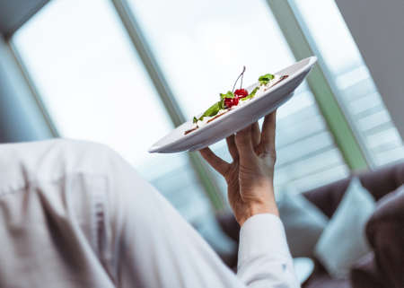 Waiter with dish at restaurant. Shallow depth of field.の写真素材