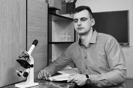 Lutsk, Volyn / Ukraine - 22 April 2017: Unknown young man with microscope in lab at universityのeditorial素材