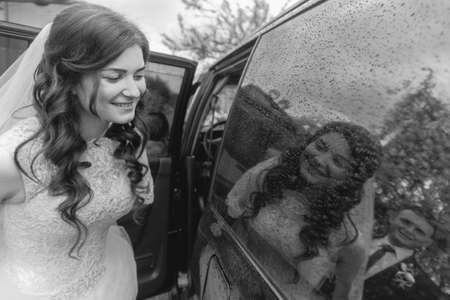 Maryanivka, Volyn / Ukraine - May 21 2017: Bride and reflexion in a windowpane of car at rainy dayのeditorial素材