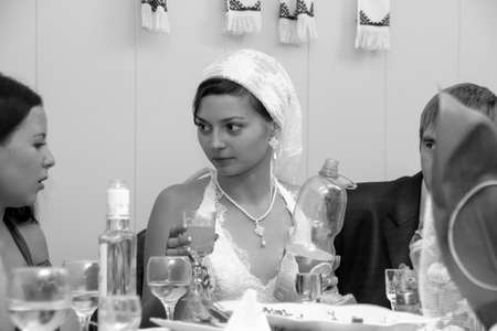 Lutsk, Volyn / Ukraine - October 12 2008: Bride in a handkerchief and bridesmaid on party at restaurant.のeditorial素材