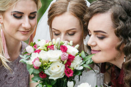 Cuman, Volyn / Ukraine - April 29 2018: Bride with a  bouquet and bridesmaids posing in parkのeditorial素材