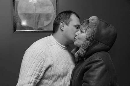 Lutsk, Volyn / Ukraine - February 06 2010: Man and woman in coat kissing at restaurantのeditorial素材