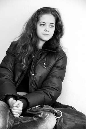 Lutsk, Volyn / Ukraine - January 25 2011: Casual young woman posing on wall background in officeのeditorial素材