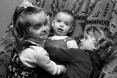 Volodymyrec, Rivne / Ukraine - April 10 2009: Little girls hugging brother at homeのeditorial素材