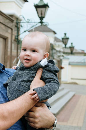 Lutsk, Volyn / Ukraine - May 18 2019: Little child in hands of man posing on streetのeditorial素材