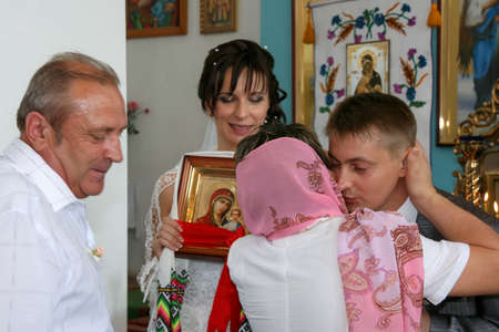 Lutsk, Volyn / Ukraine - August 30 2009: Groom and Bride on his wedding day hugging relatives at...