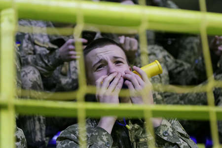 Lutsk, Volyn / Ukraine - February 15 2020: Young Fans of basketball team in arena emotionally...