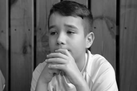 Kiverci, Volyn / Ukraine - February 08 2020: Young Caucasian teenage boy with hands on chin thinking in gym, pensive expressionのeditorial素材