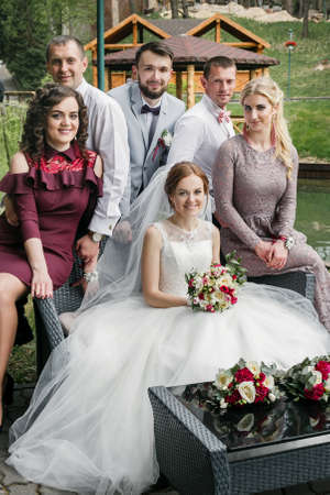 Cuman, Volyn / Ukraine - April 29 2018: Groom and bride with guests posing in parkのeditorial素材