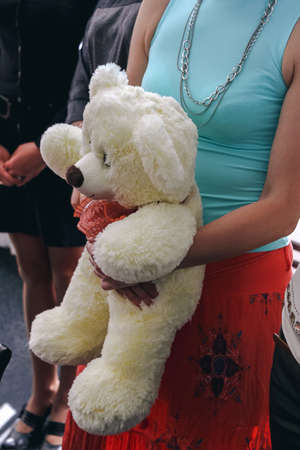 Woman hold in their hands a toy bear at office
