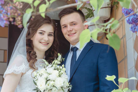 Maryanivka, Volyn / Ukraine - May 21 2017: Married couple on their wedding day posing against the wallのeditorial素材