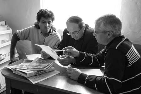 Dubrovycia, Rivne / Ukraine - September 21 2010: Three men looking to papers at home
