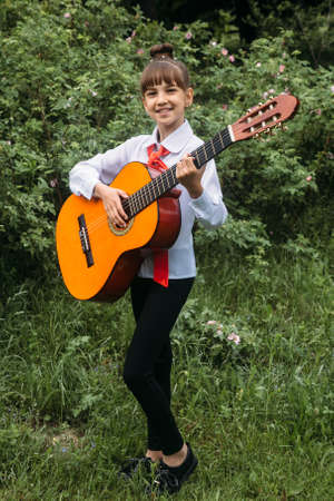 Rokyni, Volyn / Ukraine - May 29 2019: Young musician with guitar in parkのeditorial素材