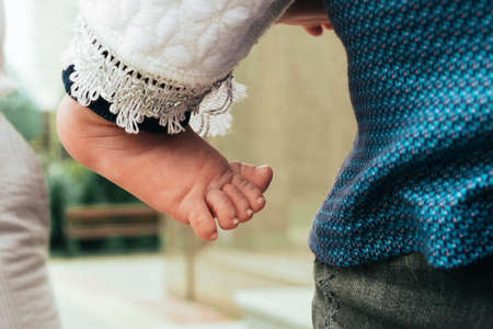 Close up of little foot of a newborn baby boy at outdoor. Shallow depth of field.の写真素材