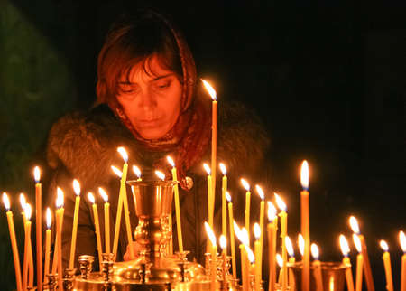 Moscow, Russia - November 23 2011: Ukrainian parishioners of the Orthodox Church light up candles