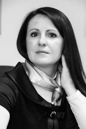 Lutsk, Volyn / Ukraine - July 24 2013: Young woman with a shawl on the neck posing in officeのeditorial素材