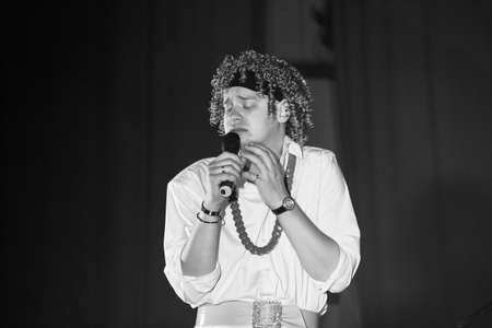 Lutsk, Volyn / Ukraine - November 24 2009: Ukrainian comedy male actor wearing wigs parody female singer during the performance indoorのeditorial素材