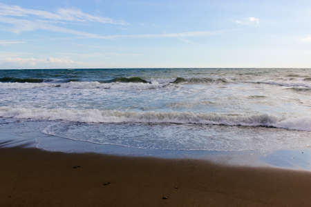 Waves wash over sand on Black Sea beachの写真素材