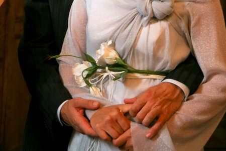 Cropped view of woman and man holding hands. Shallow depth of field.の写真素材