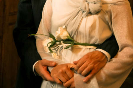 Cropped view of woman and man holding hands. Shallow depth of field.の写真素材