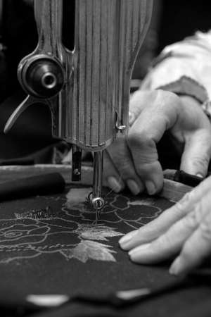 Female hands sewing on a machine. Shallow depth of field.の写真素材