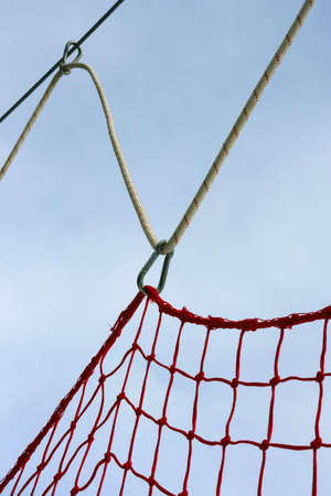 Safety guard netting with rope and carabiner against sky at ski resort