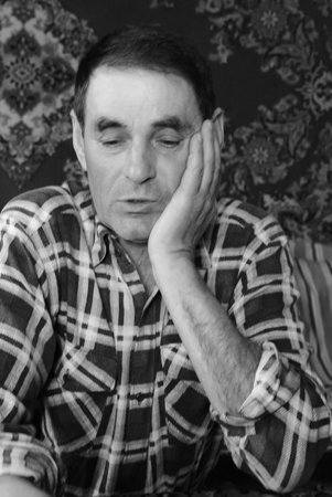 Novograd, Ukraine - April 01 2009: An unidentified senior man posing at homeのeditorial素材