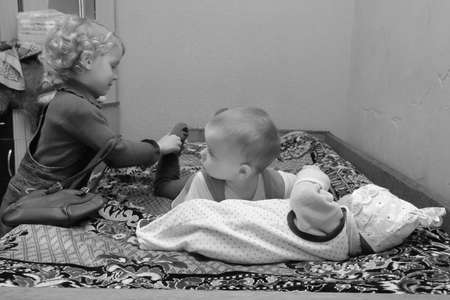 Volodymyrec, Ukraine - April 10 2009: Little kids posing with baby at homeのeditorial素材