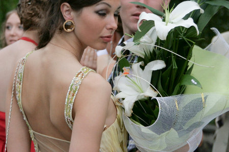 Kiverci, Ukraine - June 27 2009: Photo from the back of a slim young woman in elegant dress. Shallow depth of field.のeditorial素材