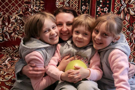 Volycia, Ukraine - March 25 2009: Woman and children posing together at homeのeditorial素材