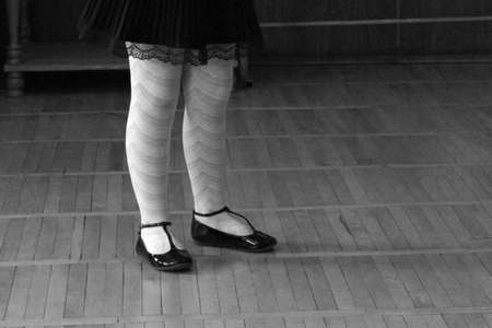 Schoolgirl legs. Close-up of feet and leather shoes.の写真素材