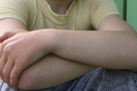 Little boy in casual clothes with crossed arms outdoors. Cropped view.の写真素材