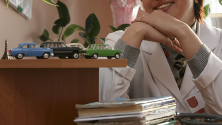 Woman and vintage model cars on shelf of table. Cropped view. Shallow depth of field. Concept of leasing and buying a car.の写真素材