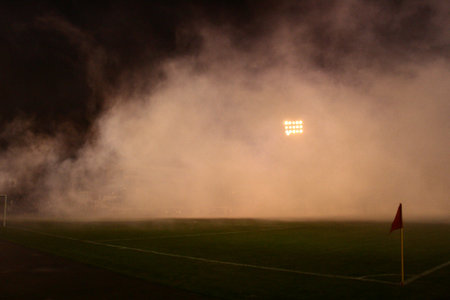 Smoke and red flag of corner on the stadium after supporters burned flares during the football gameの写真素材