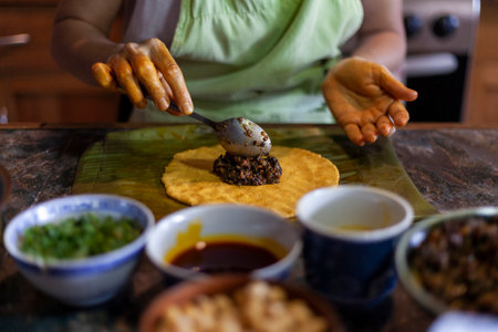 Close up of hands preparing hallaca or tamale. Traditional food conceptの写真素材
