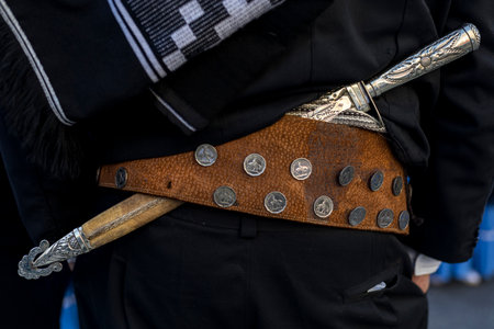 Rear view in detail of the traditional belt and knife (facon) of an Argentine gaucho. Close-up, unrecognizable person. Concept Argentine Culture and Traditionsの写真素材