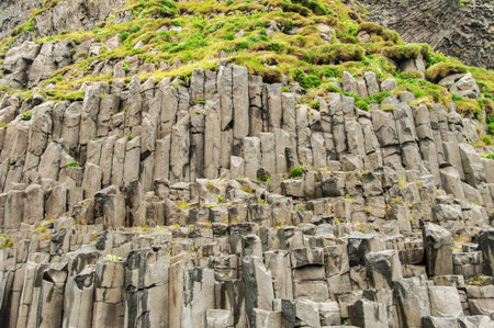Reynisfjara beach, detail of escarpment with numerous basalt columns in Icelandの写真素材